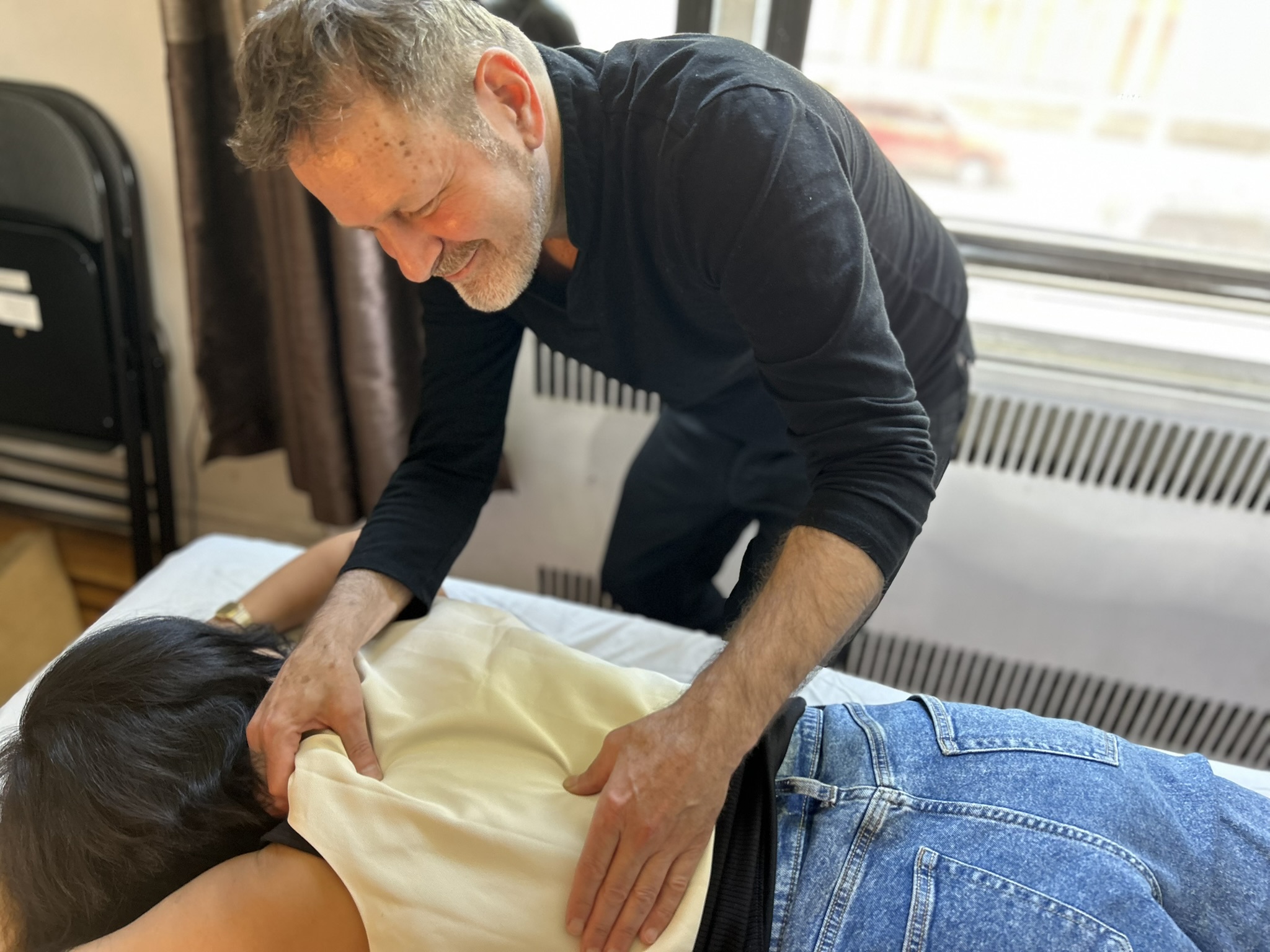 Noam performing bodywork with a client